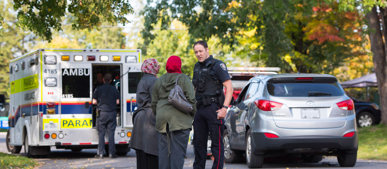 An Ottawa Police Service Officer responds to residents after a call