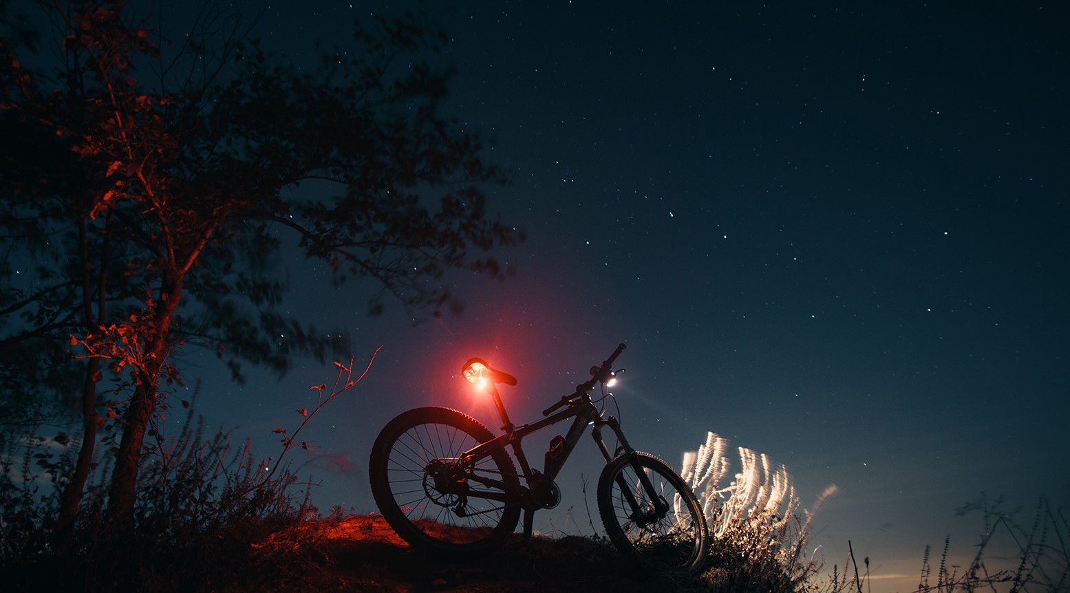 Image of a bicycle after sunset with a bright light